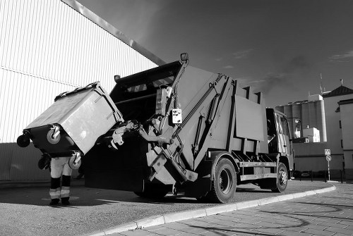 Charity volunteers collecting refurbished furniture from a skip